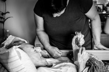 Přála si jít domů. Dcera jí její přání splnila.  nemocná žena si prohlíží látkové srdíčko